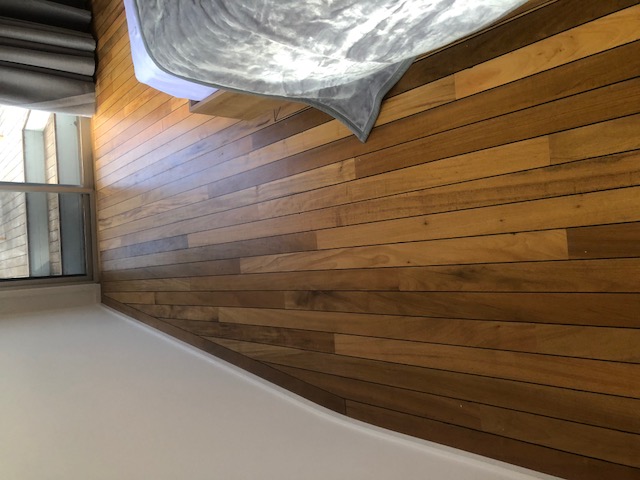 Polished hardwood timber flooring installed in a Mackay bedroom